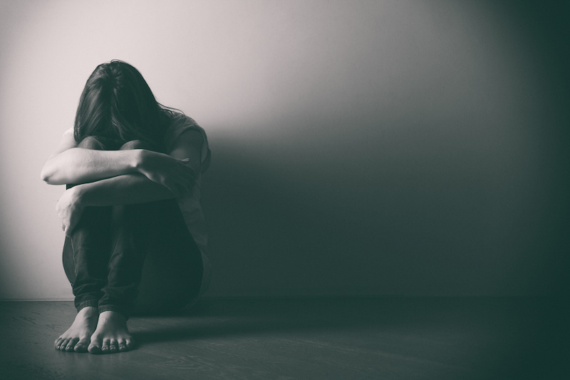 teenager girl depression sitting alone on floor