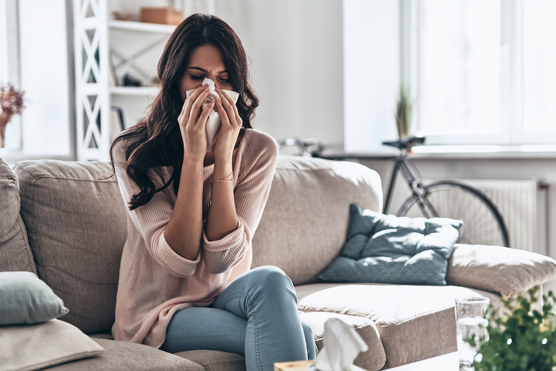 allergic rhinitis woman blowing her nose